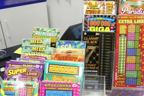 Wybór zdrapki lotto, która najczęściej wygrywa, to marzenie graczy. Na zdjęciu widać bogaty wybór zdrapek, od "Mega Milionów" po "Super Linię", zachęcających do gry.