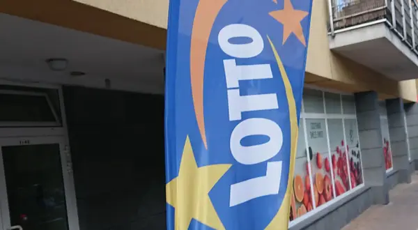 Niebieska flaga z logo LOTTO i gwiazdami. Szukasz rankingu zdrapek lotto z największym prawdopodobieństwem trafienia?