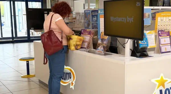 Kobieta z rudymi włosami kupuje losy Lotto. Czy lottomaty na stacjach benzynowych mają inne prawdopodobieństwo?