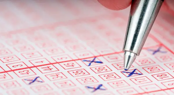Długopis zaznacza liczby na kuponie lotto. Czy ktoś wygrał w lotto przez internet?