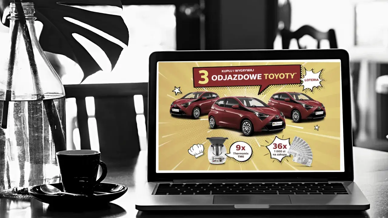 Na ekranie laptopa reklama loterii z samochodami Toyota. Czy loterie z samochodami w internecie są w pełni legalne w Polsce? Sprawdź!