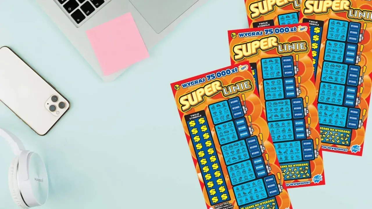 Trzy zdrapki "Super Linie" leżą obok telefonu i słuchawek. Szansa na wygraną 75 000 zł!