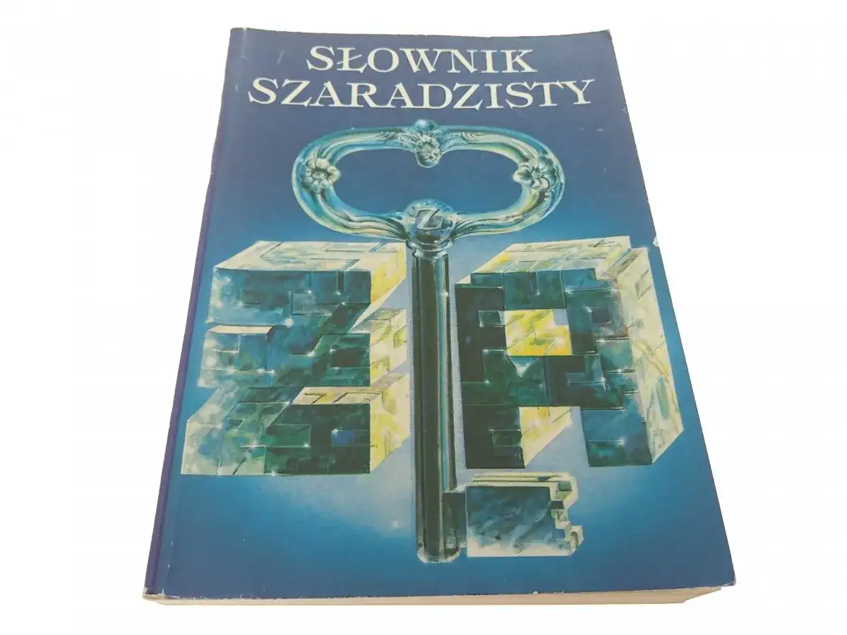 Słownik szaradzisty: klucz do efektywnego szukania trudnych i nietypowych haseł. Okładka z kluczem i kostkami.