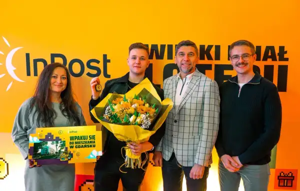 Szczęśliwiec, kto wygrał mieszkanie w loterii InPost, odbiera klucze i bukiet.